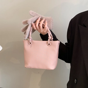 Pink vertical pleated bucket bag with round handles and chic minimalist vintage design