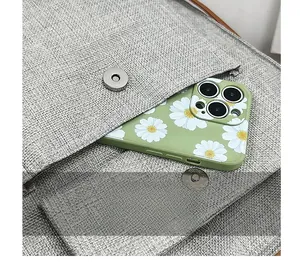 Detailed view of grey linen crossbody bag featuring a front pocket with magnetic closure