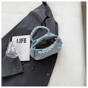 Inside view of a light blue pleated crossbody bag with a braided handle and chain strap