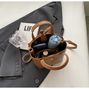 Top view of brown bucket bag interior showing capacity for umbrella and phone