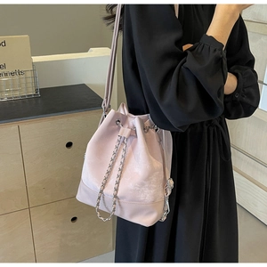 Close-up of pink bucket bag with frosted leather finish and silver chain drawstring