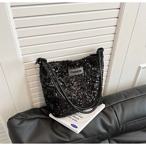 Close-up of black sequined bag texture with FASHION label on a modern sofa