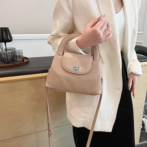 Chic beige quilted crossbody bag with silver twist lock and adjustable shoulder strap