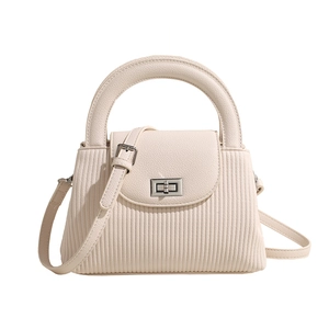 Minimalist beige quilted handbag with vertical stripes, metal clasp, and top handle strap