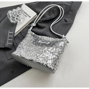 Detailed macro view of silver sequin texture with fashion logo on chain shoulder bag