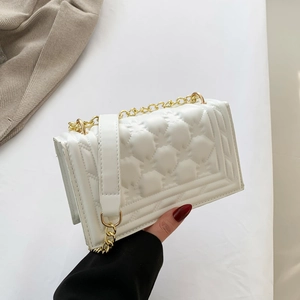Minimalist white quilted leather crossbody bag with gold chain and flap closure