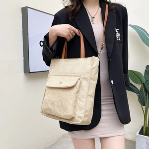 Linen tote bag with front pocket and brown leather straps for urban casual style