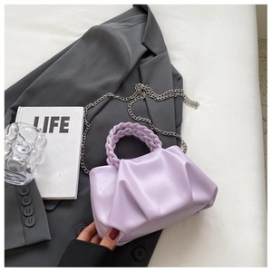 Detail of lavender pleated cloud bag with braided handle and silver chain strap