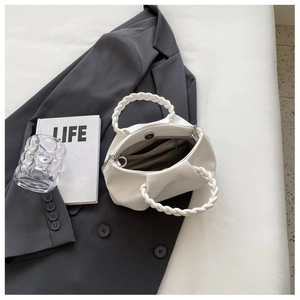 Top view of white ruched cloud bag with woven ring handle and internal pocket sections