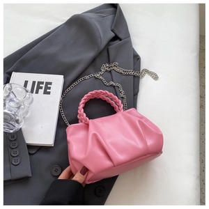 Pink pleated cloud bag detail featuring woven handle and silver metal chain strap