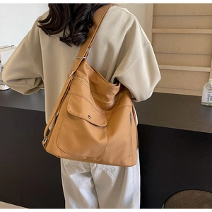Detailed view of caramel nylon shoulder bag with multi-pocket design and adjustable strap