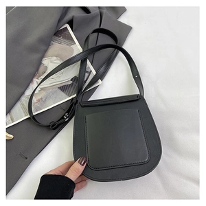 Detailed back view of a black leather saddle bag with an external pocket and slim strap