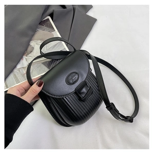 Detailed view of black vintage mini crossbody bag featuring vertical striped pleats and flap