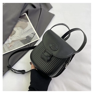 Detail of black vertical texture and flap design on a retro PU leather crossbody bag