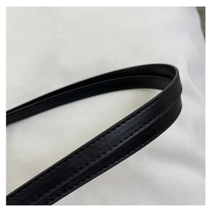 Detailed close-up of durable black leather shoulder strap with reinforced double stitching