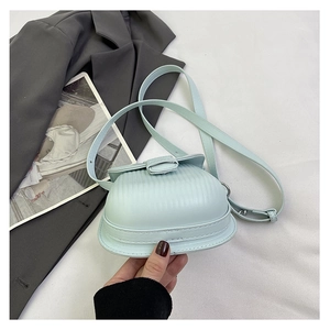 Detail of mint blue mini crossbody bag with vertical pleated texture and slim strap