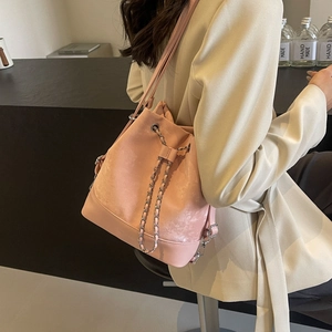 Pink drawstring bucket backpack with silver chain and matte faux suede texture