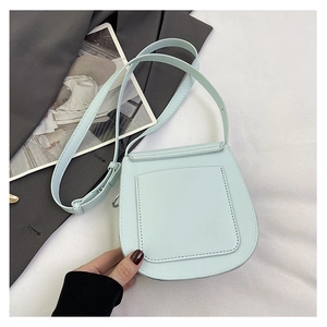 Close-up of mint green crossbody bag featuring a practical rear card slot and fine stitching