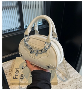 Detailed shot of off-white Boston bag with silver chain and vintage metallic hardware