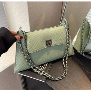 Detail der mintgrünen Stepptasche aus PU-Leder mit dunkelgrauem Metall-Drehverschluss und Kette