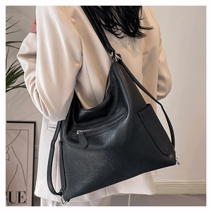 Dettaglio borsa hobo nera in finta pelle con texture stropicciata vintage e zip in argento