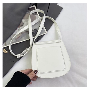 Detail of minimalist white PU leather crossbody bag with back pocket and adjustable strap