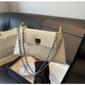 Detailansicht der cremeweißen gesteppten PU-Ledertasche mit silbernem Drehverschluss und Kette