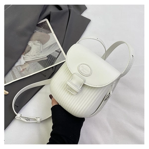 Detail of cream white crossbody bag with vertical pleated texture and silver buckle
