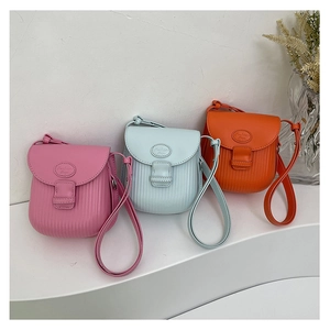 Detailed view of mini crossbody bags with pleated texture in pink, blue, and orange