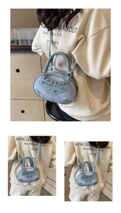 Close-up of light blue mini round handbag with metal rivets and chain strap detail