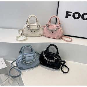 Detail of colorful mini round crossbody bags with punk rivets and silver chain decoration