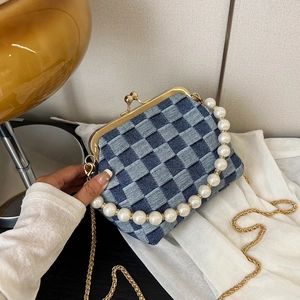 Denim checkerboard crossbody bag with elegant pearl handle and gold clasp closure