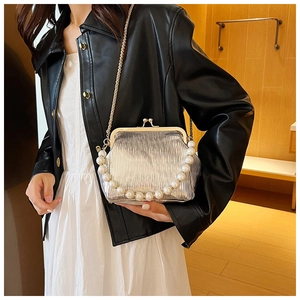Sac à fermoir plissé argenté avec anse en perles et chaîne porté par un mannequin