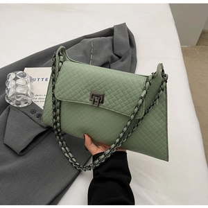 Detail der avocado-grünen Stepp-Schultertasche mit einem Vintage-Metall-Drehverschluss