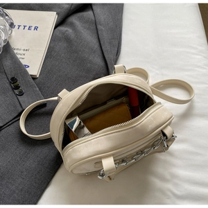 Detailed internal view of the cream white crossbody bag showing storage capacity