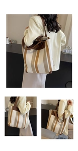 Detail view of large canvas tote bag with khaki stripes and dark brown leather accents