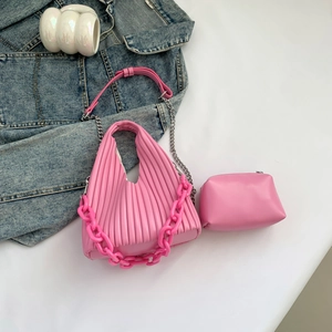 Detail of pink pleated PU leather shoulder bag with resin chain and matching mini pouch