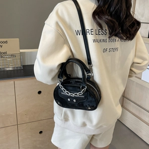 Chic black textured leather half-moon handbag with silver studs and chain strap