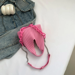 Detail view of pink pleated PU leather crossbody bag with chunky plastic and metal chains