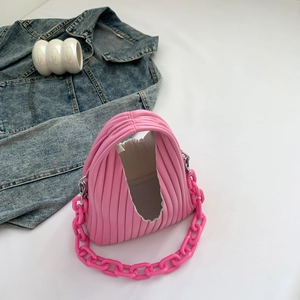 Detail of pink pleated PU leather handbag with chunky decorative chain strap