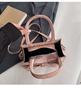 Pink crossbody bag interior view showing large space and zippered middle compartment