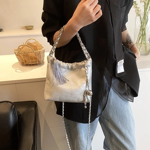 Detailaufnahme der silbernen Beuteltasche mit Kordelzug und Fransen-Anhänger