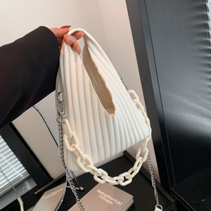 Detail of white pleated bucket bag featuring resin link chain and silver metal shoulder strap