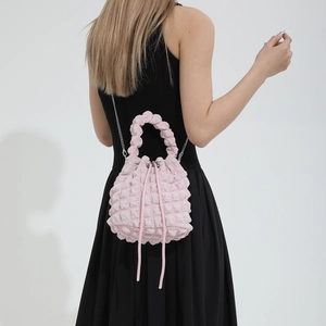 Pink bubble textured bucket bag with drawstring closure and silver chain strap for women
