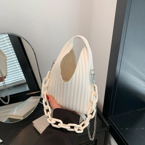 Detail of white pleated PU leather handbag featuring resin and metal chain straps