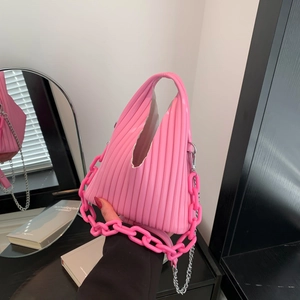 Close-up of pink pleated PU handbag showing triangular shape and chunky chain detail