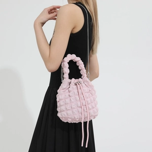 Detail of pink bubble texture drawstring bucket bag with silver metal chain strap