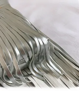 Gros plan des franges argentées métallisées sur un grand sac cabas en similicuir souple