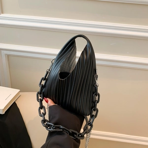 Detail of black pleated PU handbag with resin chain and silver metal shoulder strap