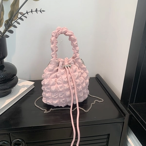 Close-up of pink bubble pleated texture on mini bucket bag with silver metal chain strap